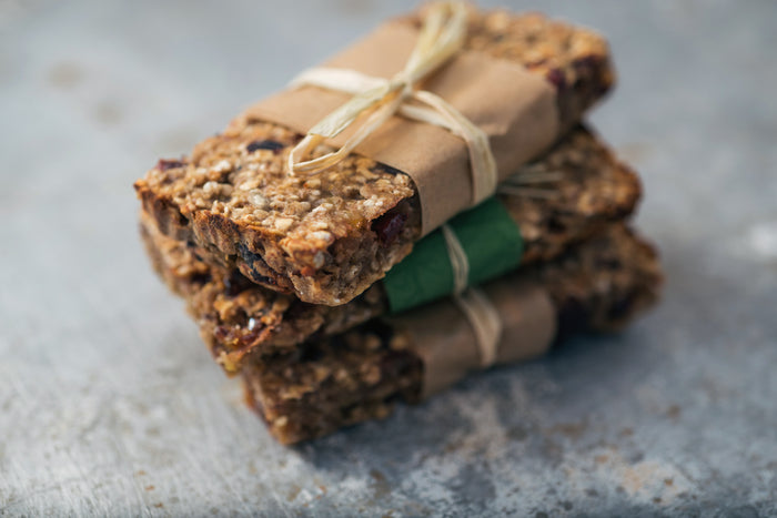 Stack of cannabis granola bars tied with twine on a textured surface